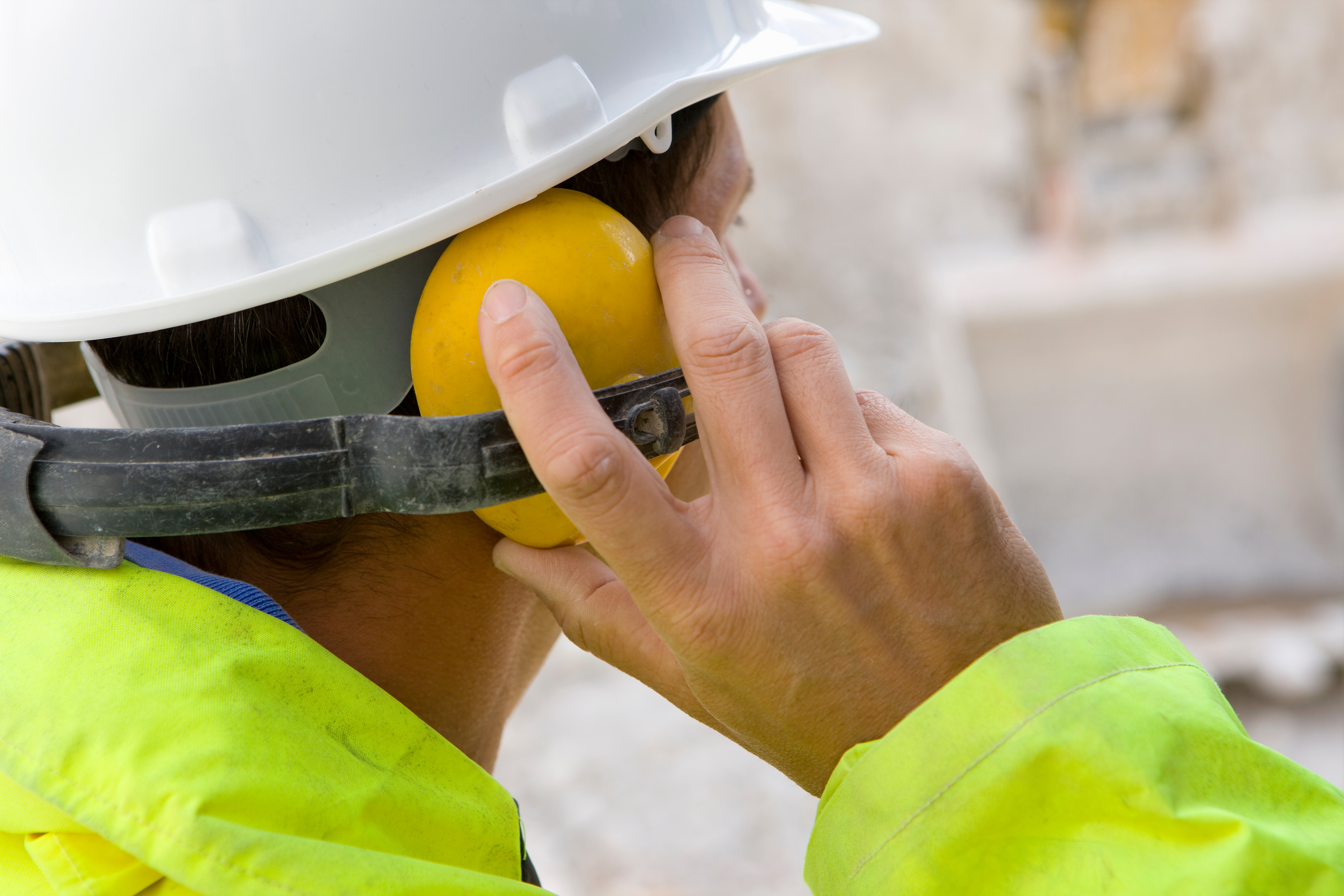 Man with Ear Defenders at Construction Site